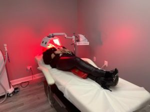 Woman receiving red LED treatment at AnewSkin Medspa