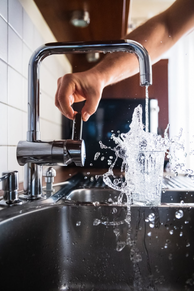 Filling a glass with water.